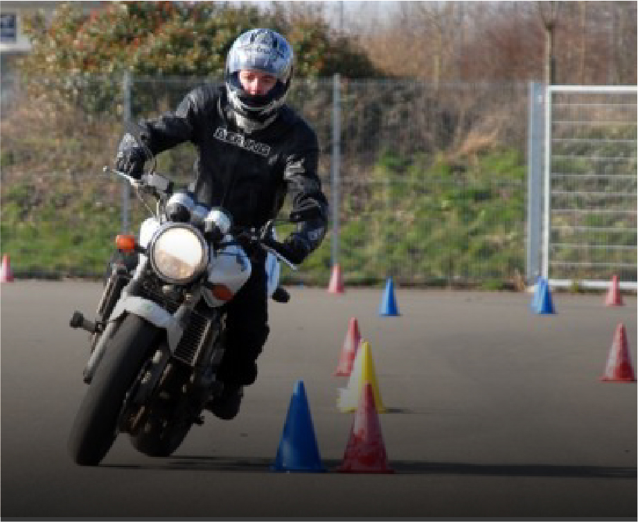 Experienced Riders Course Motorcyclist demonstrating advanced handling skills with traffic cones