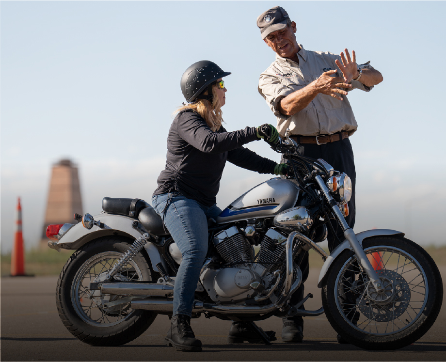 Beginner-Moto-safety-course Woman on motorcycle receiving safety instruction
